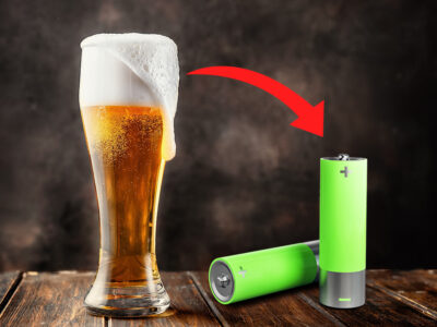 A beer filled glass, with an arrow pointing at some batteries