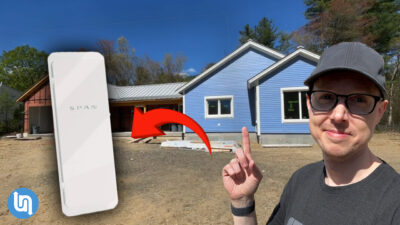 Matt Ferrell in front of his net zero home, with a SPAN panel