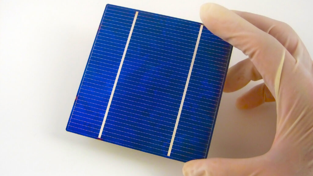 Gloved hand holding a Solar Cell