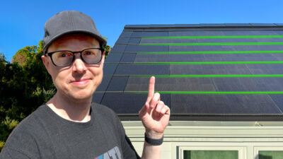 Matt Ferrell pointing at a Tesla Solar roof