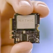 A hand holding a Mythic computer chip