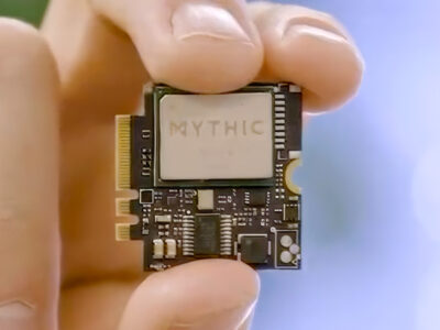 A hand holding a Mythic computer chip