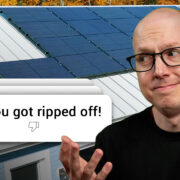 Matt Ferrell in front of his Solar roof looking at a comment that says "You got ripped off!"
