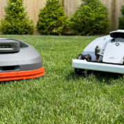 Two robot lawn mowers, the Segway Navimow H1500-VF and the Mammotion Luba 2 AWD 3000H next to each other on a lawn