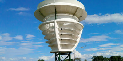 A shroud covered rooftop wind turbine